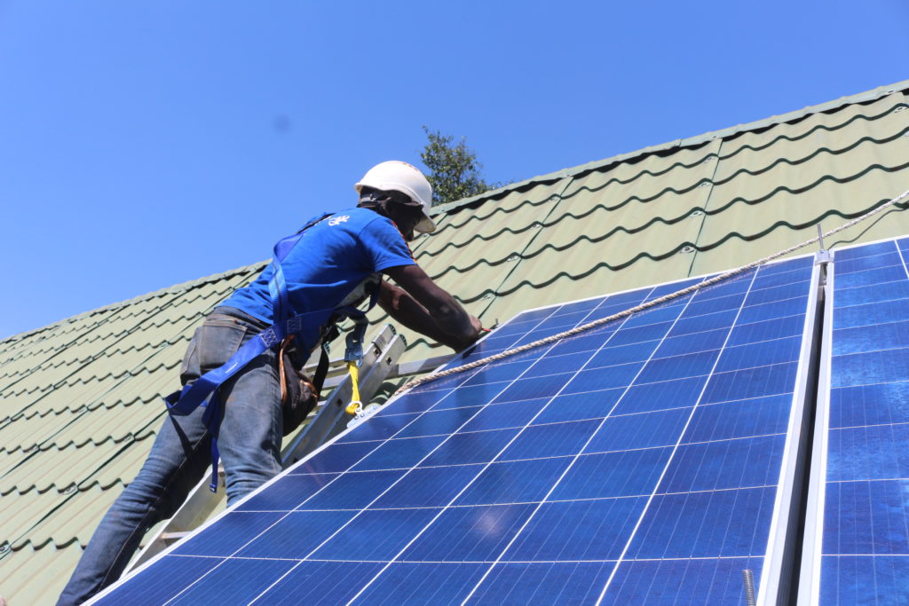 man installing solar