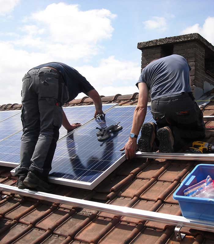 men installing solar